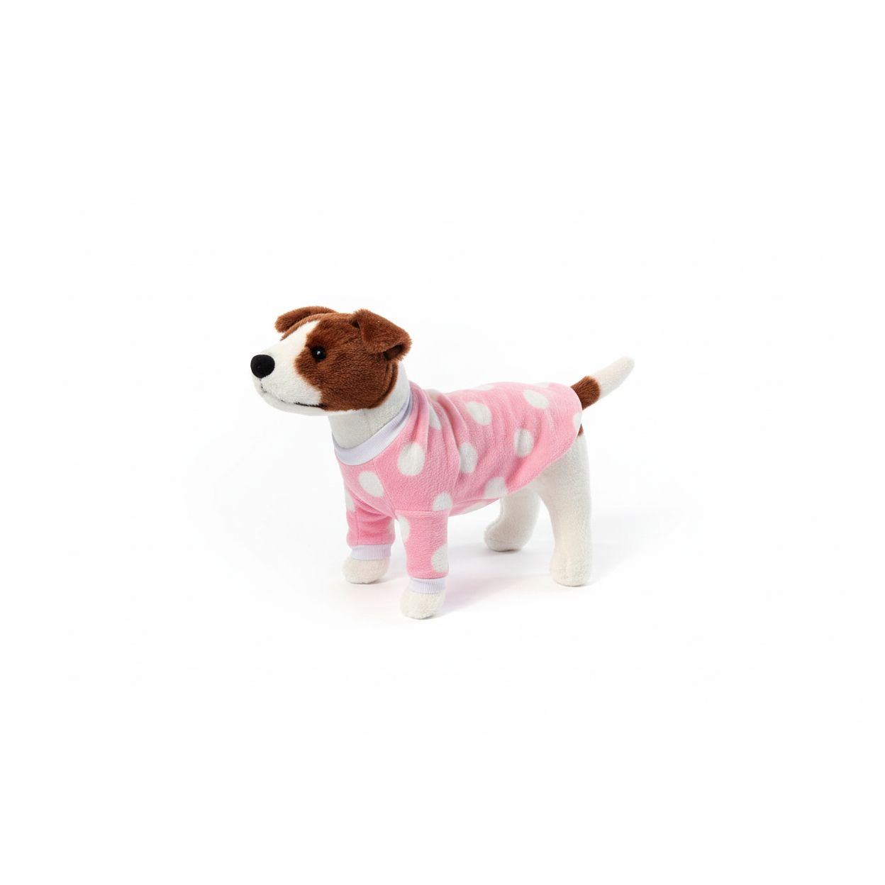 dog wearing a pink polka dot outfit on a beige couch.