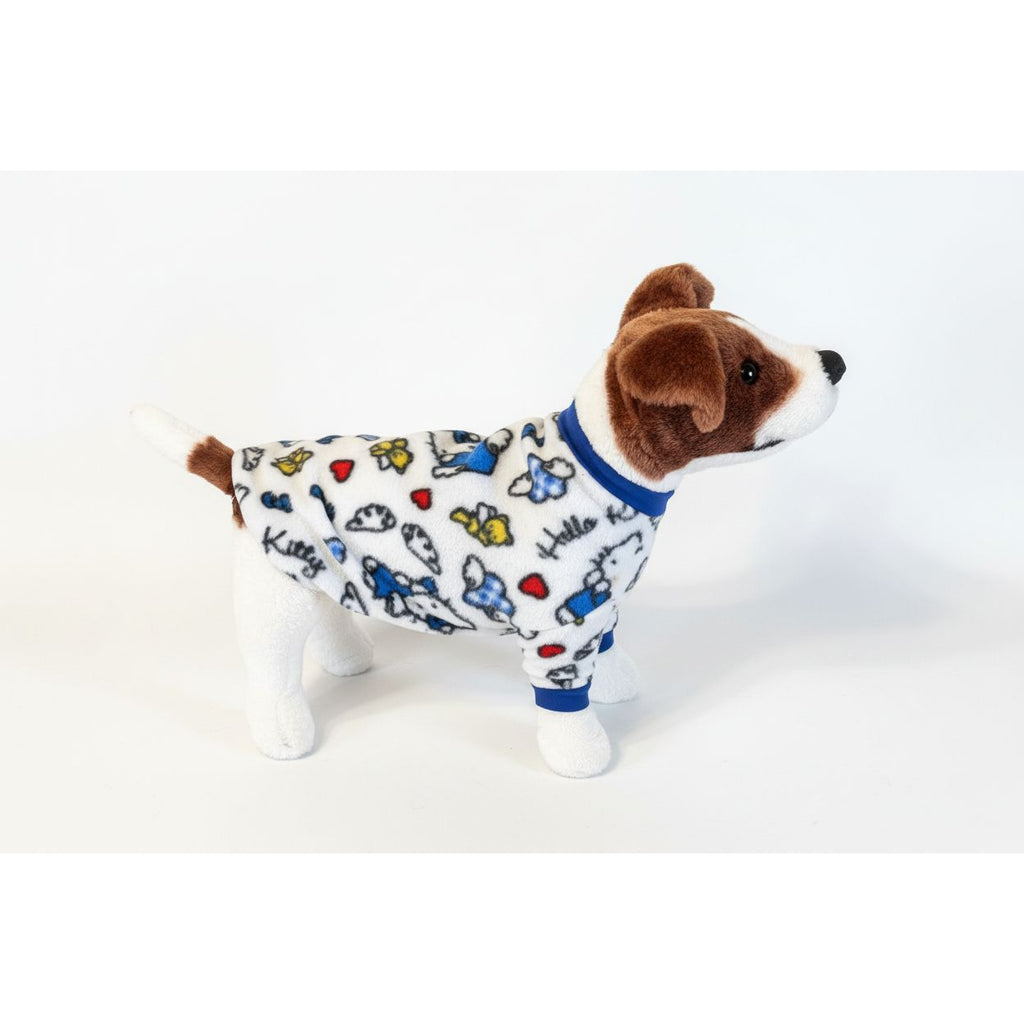 Dog wearing a colorful hello kitty fleece sweater  on a beige couch.