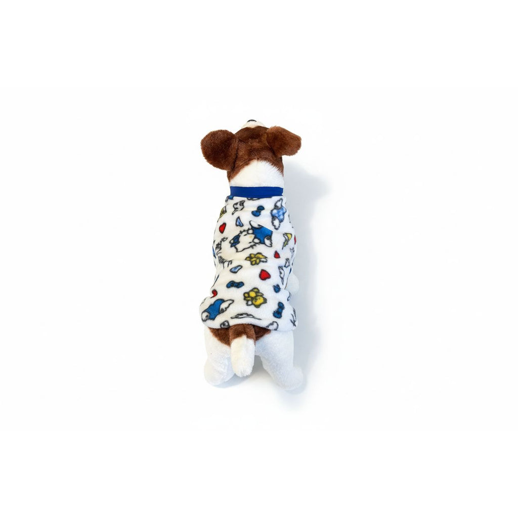 Dog wearing a colorful fleece sweater on a beige couch