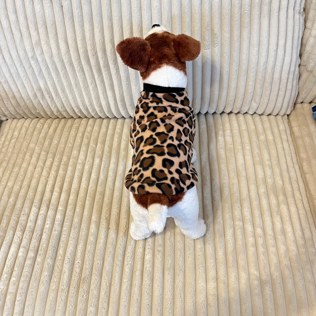 Leopard print fleece dog sweater with black trim.