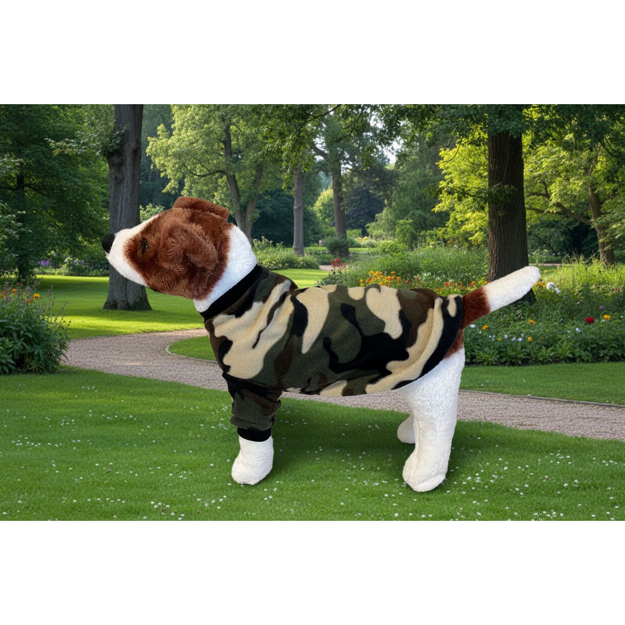 Dog wearing a camouflage outfit sitting on a textured surface