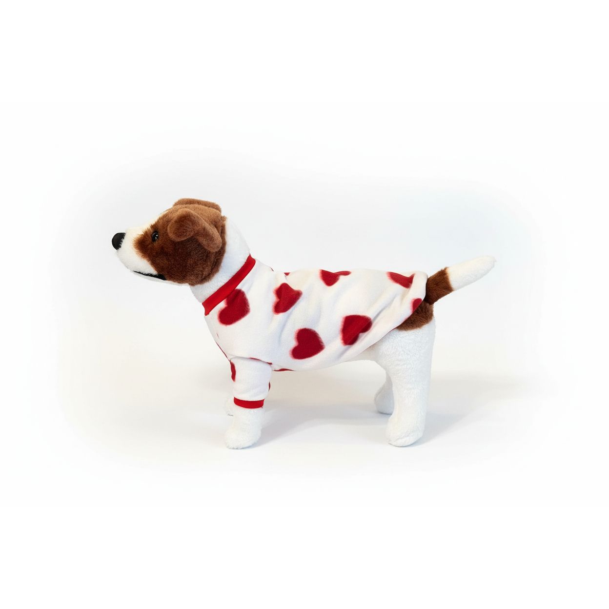 Dog toy resembling a dog in a heart-patterned outfit on a textured beige surface