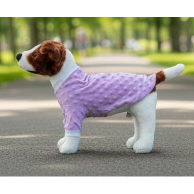 Dog wearing a purple fleece coat on a beige couch