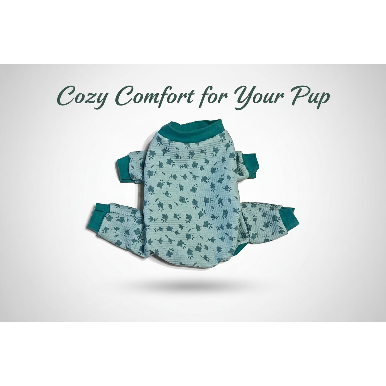 Green floral-patterned dog pajamas on a beige marble surface