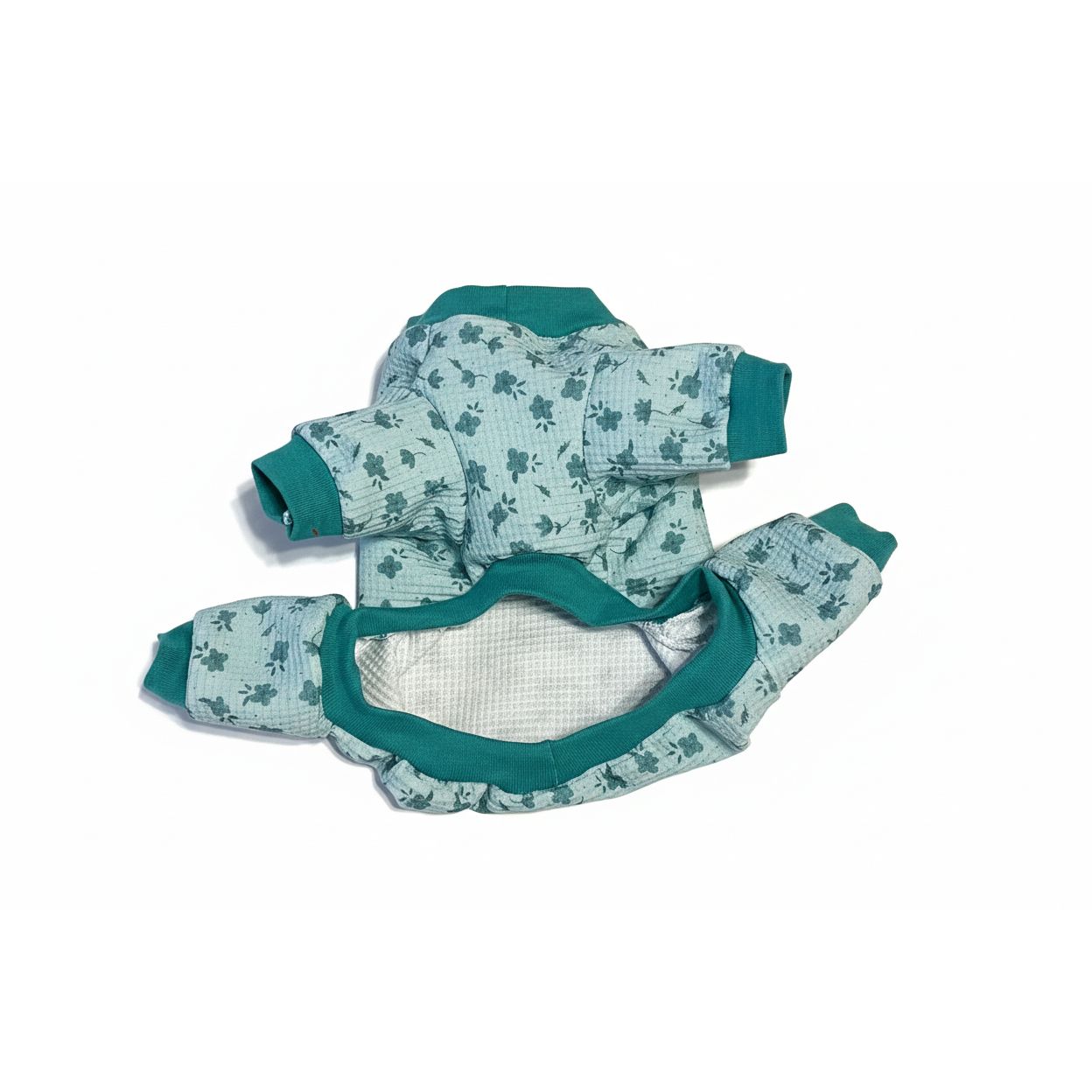 dog pajamas with green and blue pattern on a beige surface