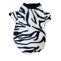 Zebra patterned pet sweater on a wooden surface