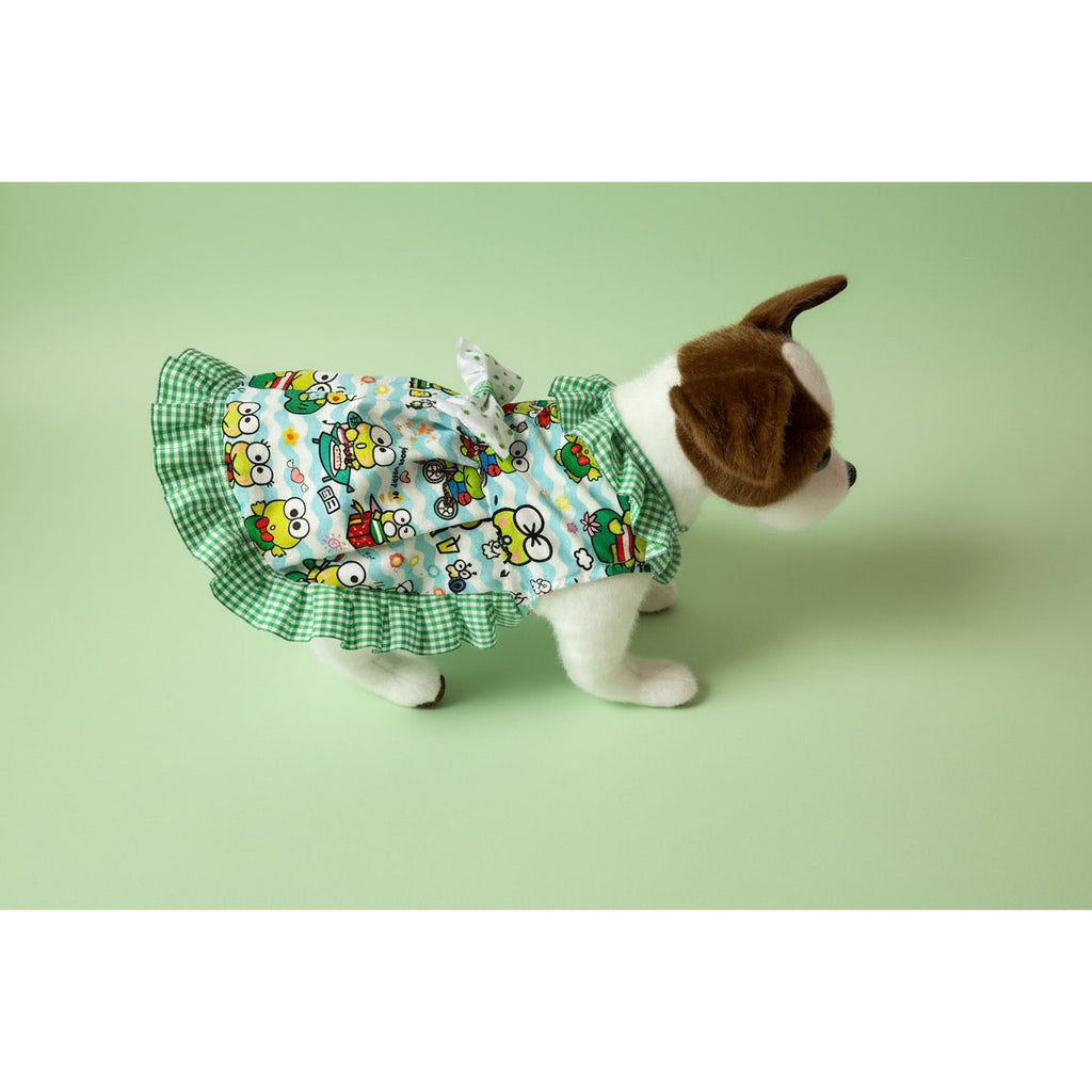 Dog wearing a colorful dress with cartoon characters on a white background