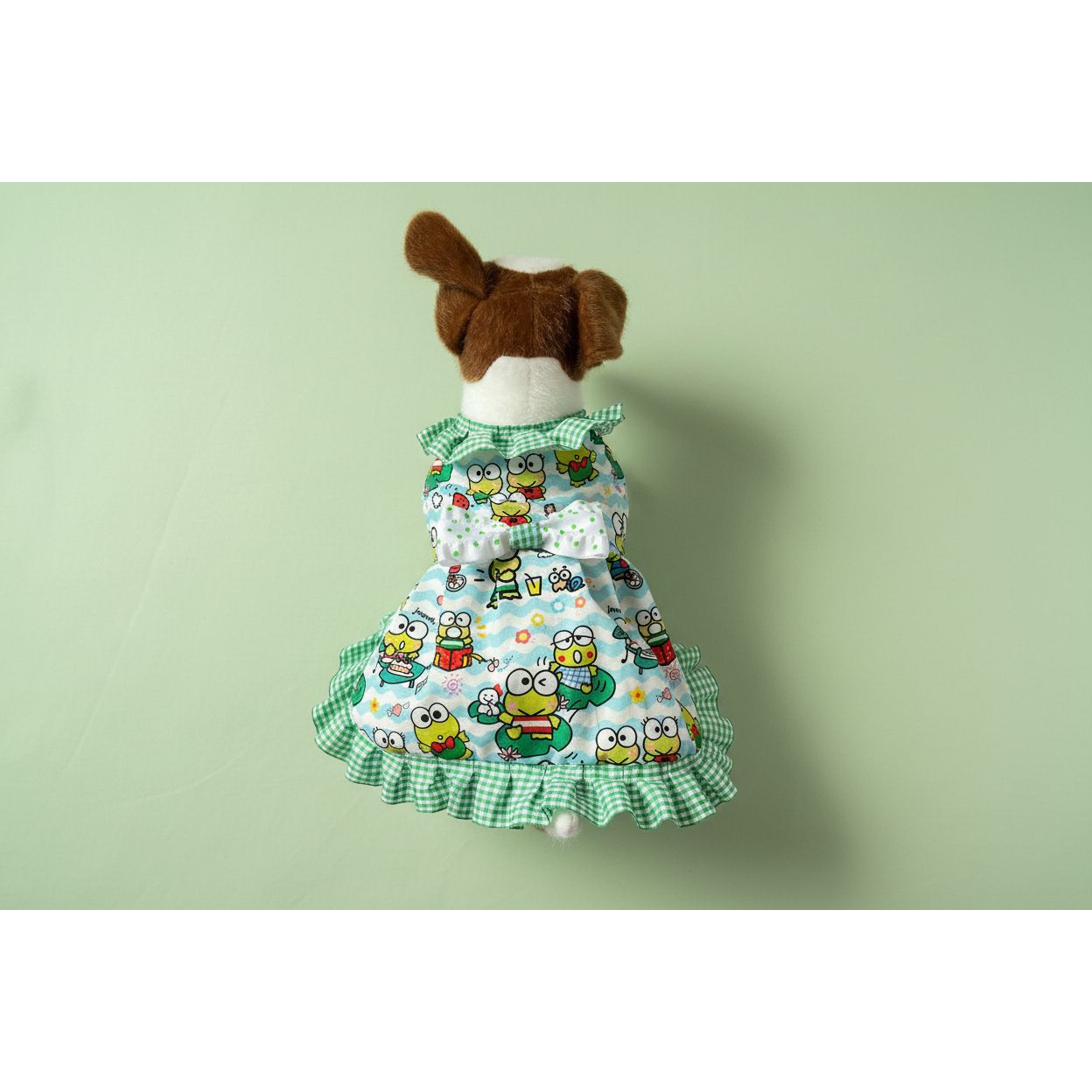 Dog dress with cartoon frog pattern on a white background