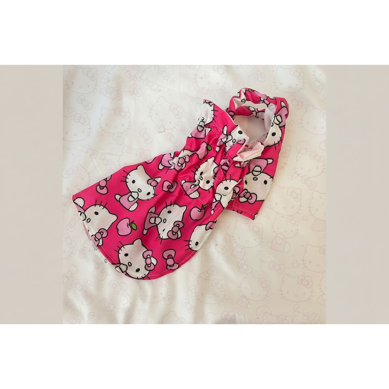 Pink Hello Kitty patterned baby carrier on a white background