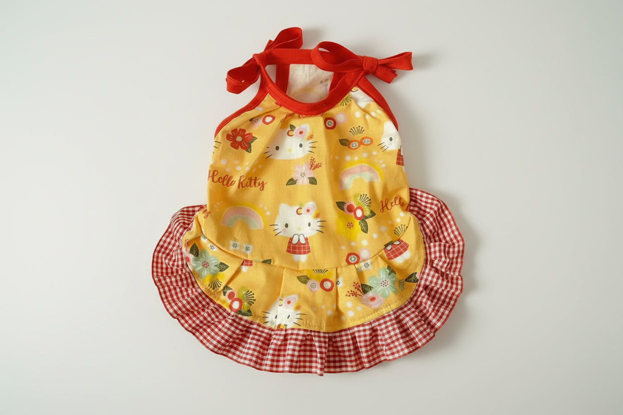 Yellow dress with red checkered skirt and Hello Kitty design on a white background