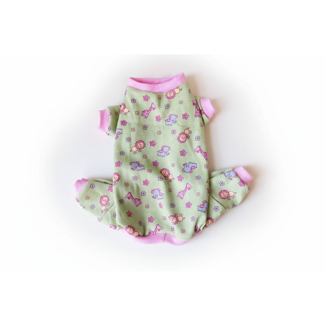 Green dog pajama set with animal patterns on a pink surface