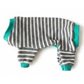 Striped pet outfit with teal accents on a beige surface
