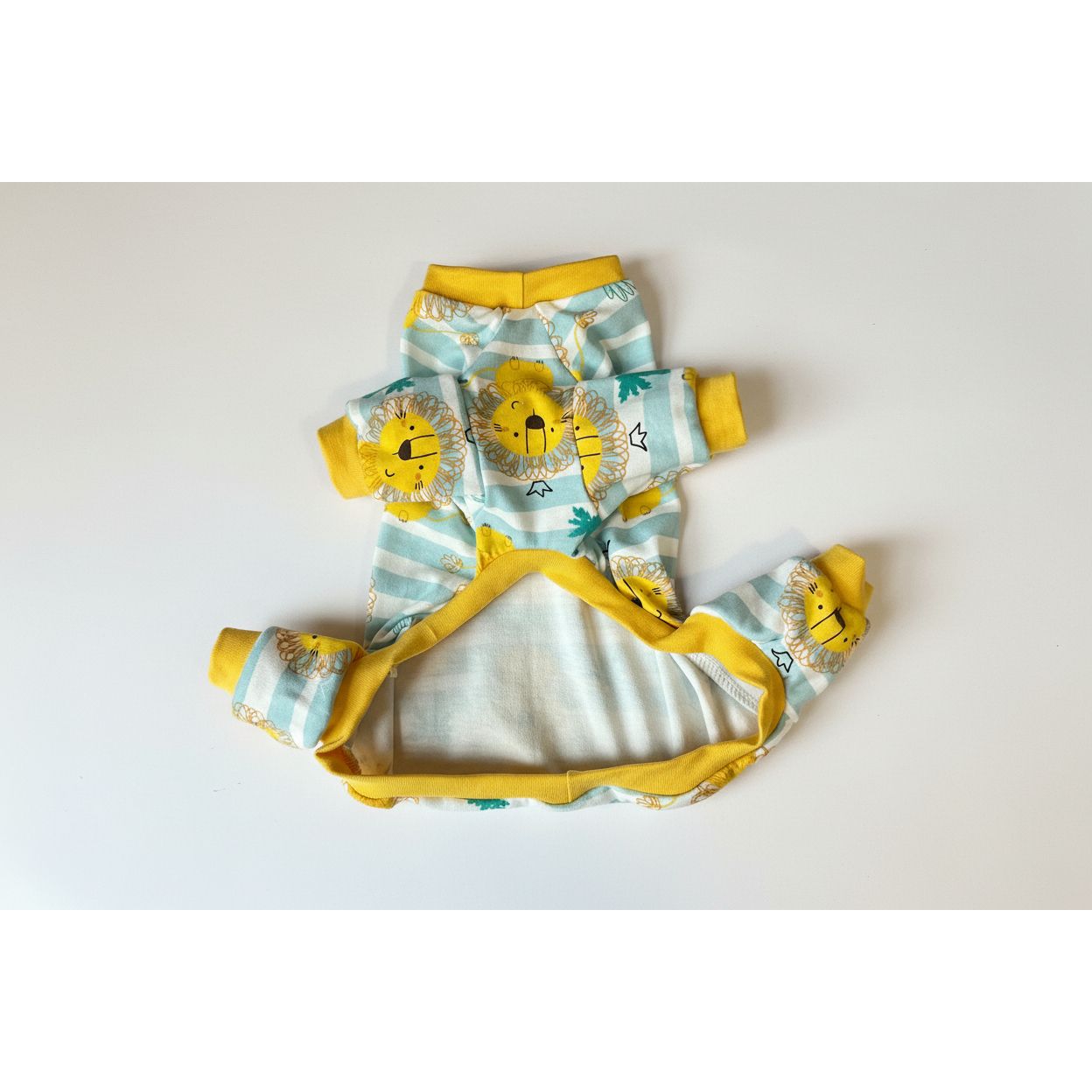 dog pajamas with lion design on a light pink background