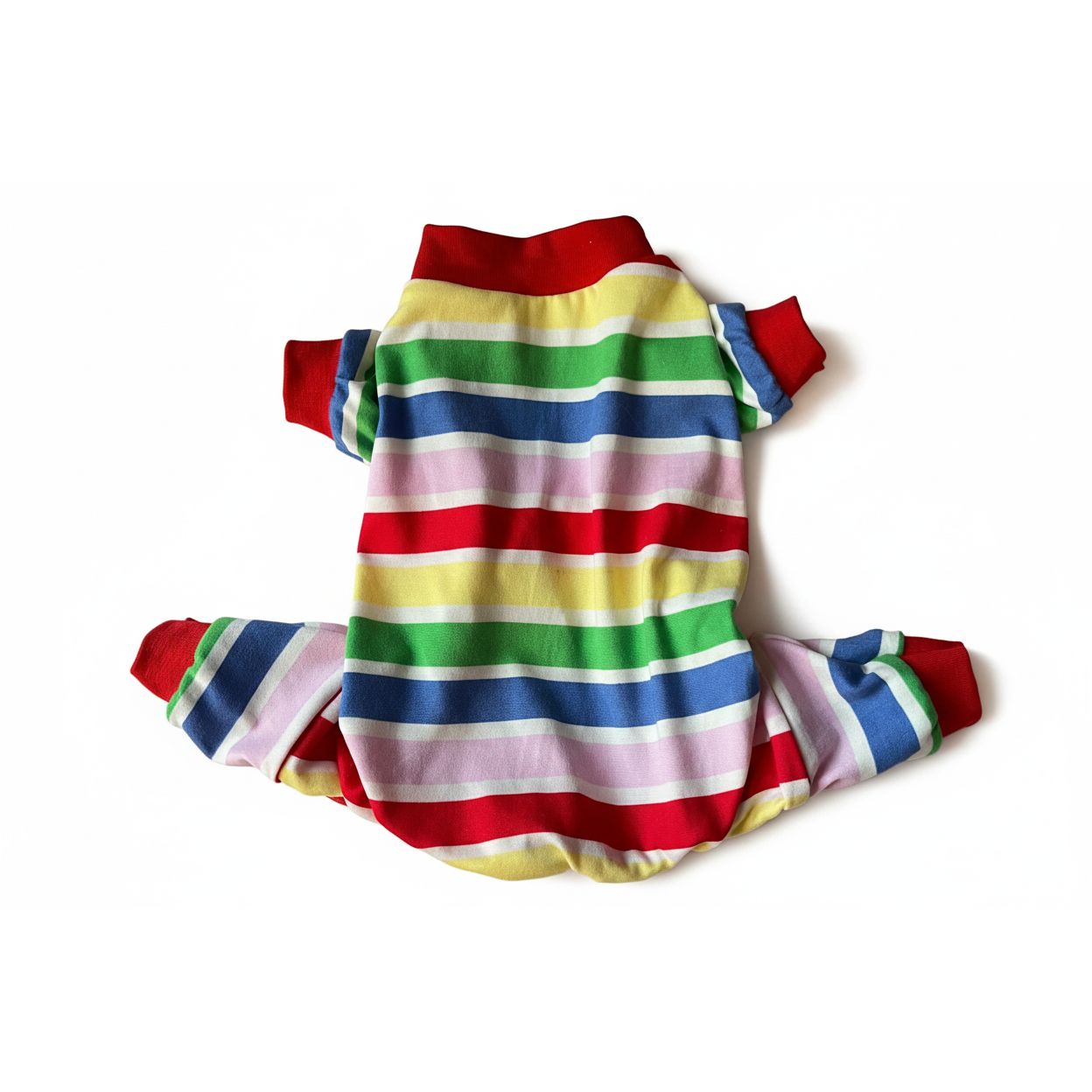 Colorful striped dog pajamas on a light pink surface