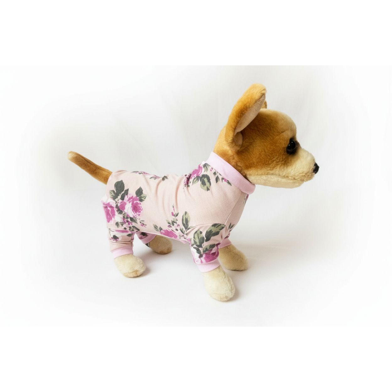 Stuffed dog toy wearing a floral outfit on a white background