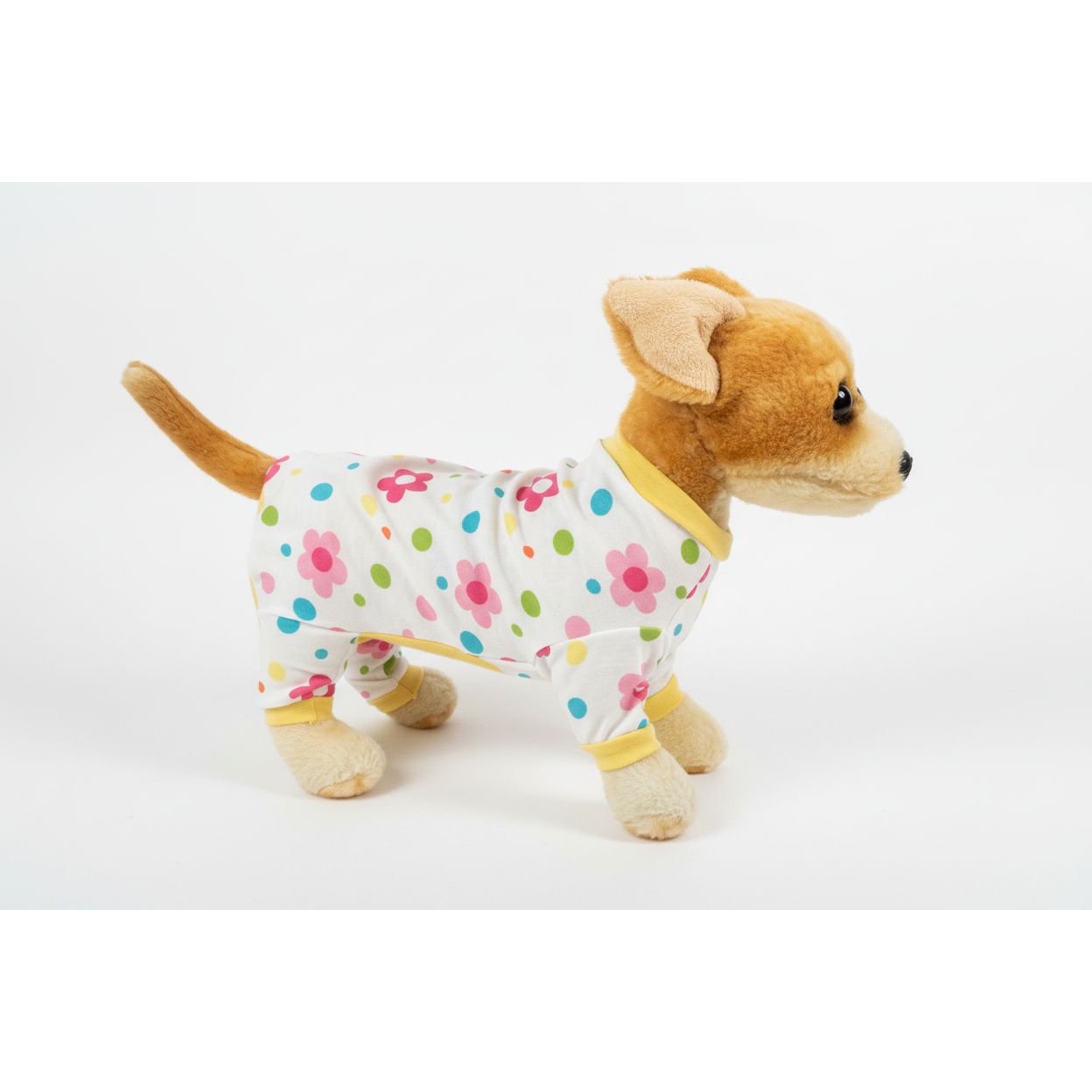 Stuffed dog toy wearing a floral outfit on a plain background