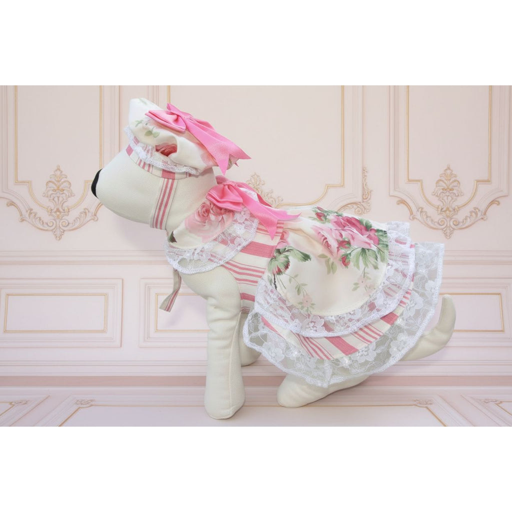 Stuffed animal in a floral dress with pink accents on grass