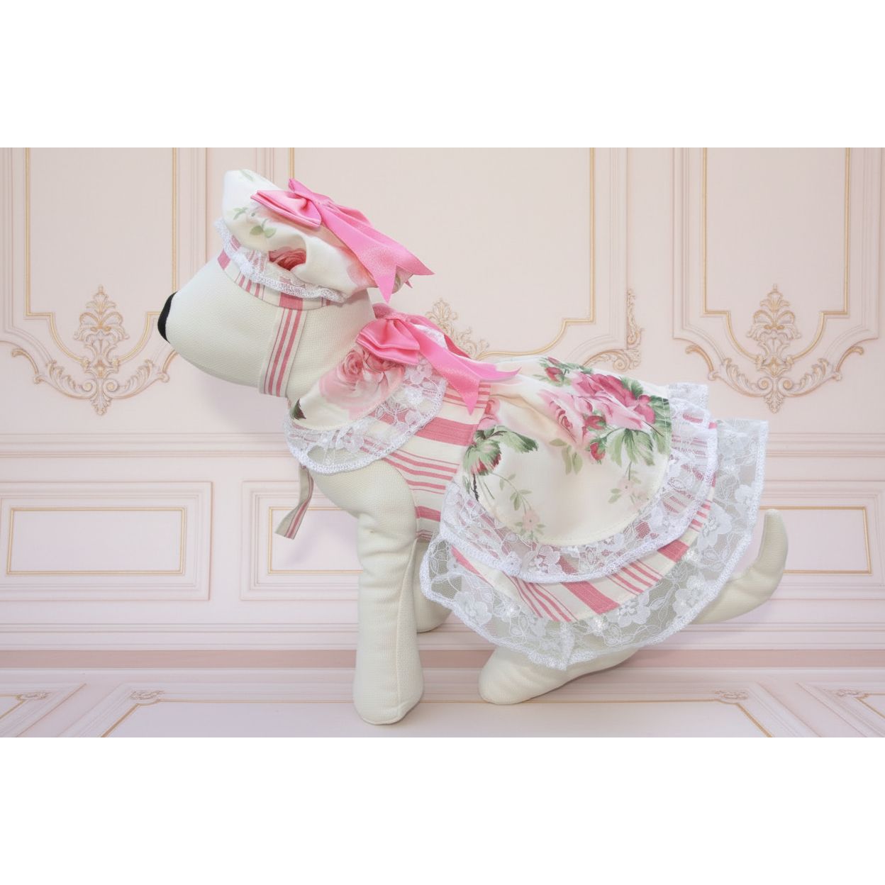 Stuffed animal in a floral dress with pink accents on grass